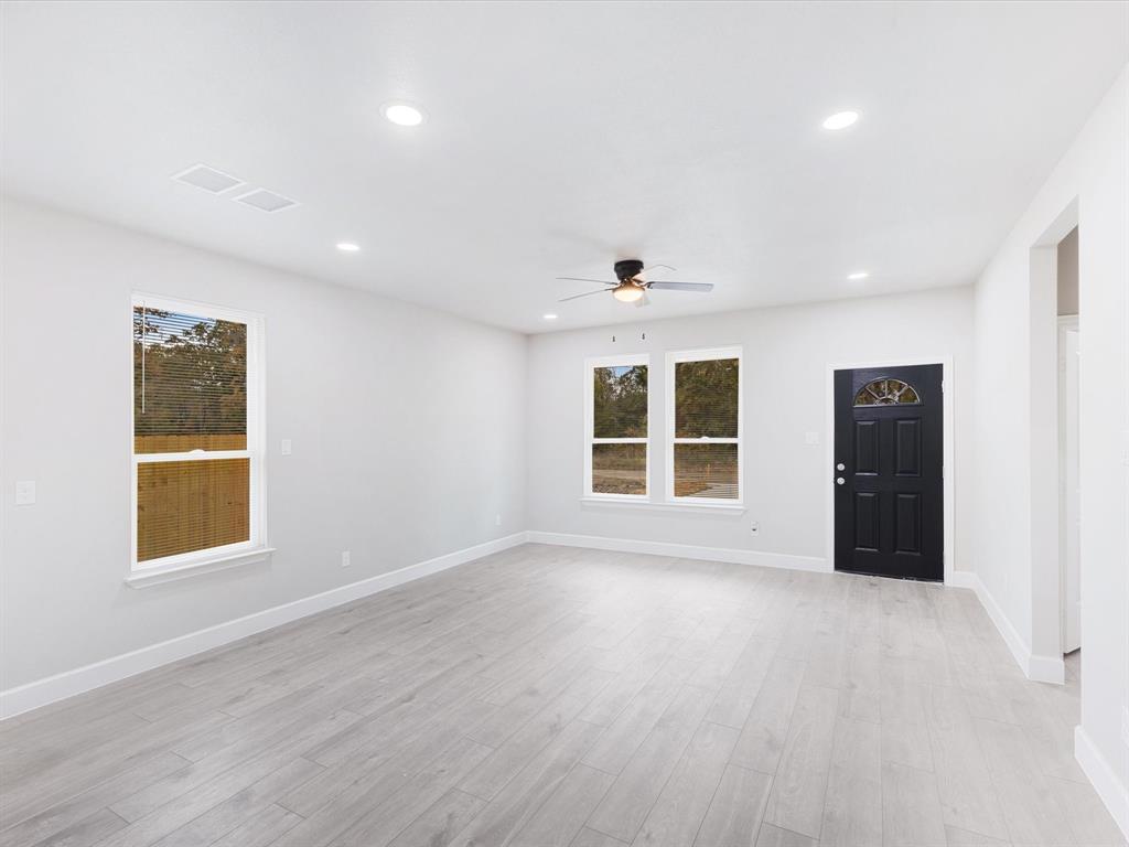 6126 Inca Drive Mabank, TX 75156 - Photo 11 of 31 an empty room with wooden floor and windows