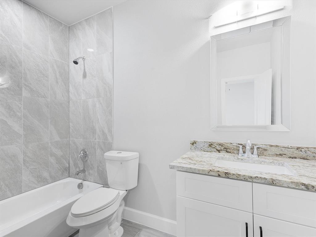 6126 Inca Drive Mabank, TX 75156 - Photo 15 of 31 a bathroom with a granite countertop sink toilet and shower