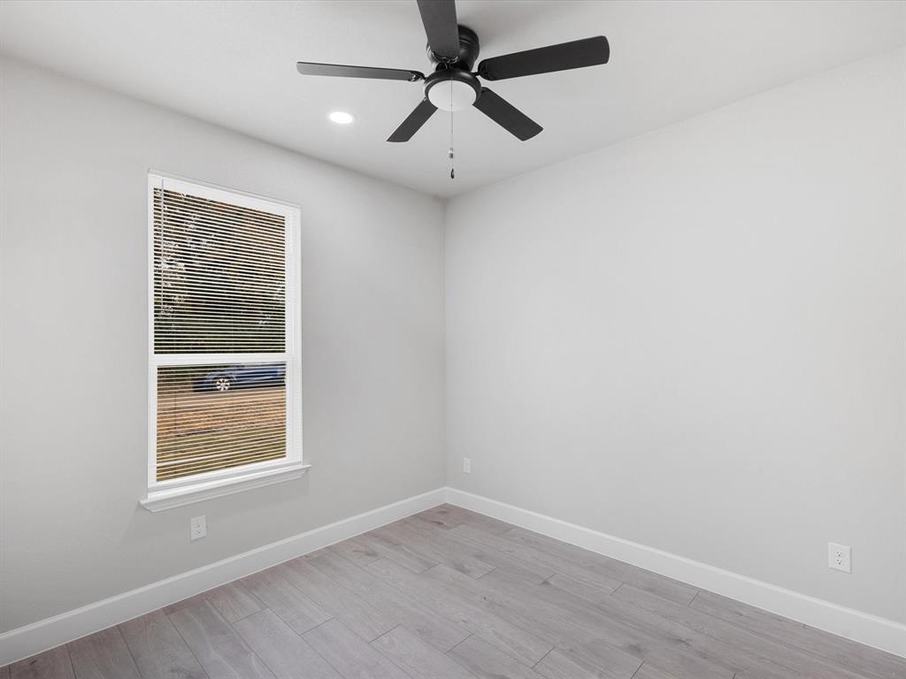 6126 Inca Drive Mabank, TX 75156 - Photo 18 of 31 an empty room with a window and a ceiling fan