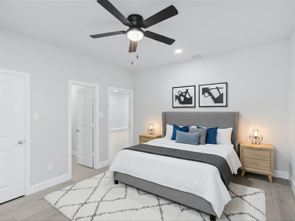 6126 Inca Drive Mabank, TX 75156 - Photo 7 of 31 a bedroom with a large bed and a chandelier