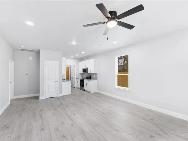 a view of an empty room with a window