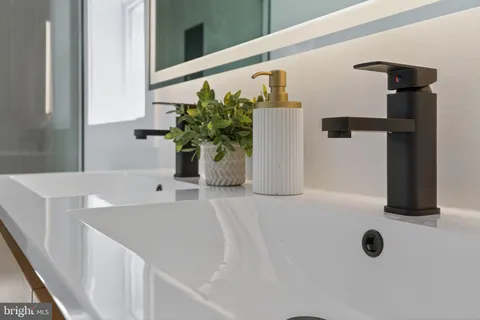 a bathroom with a sink and mirror
