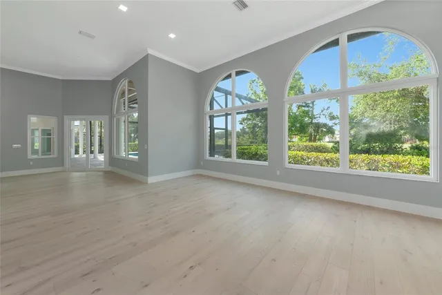 an empty room with windows and closet