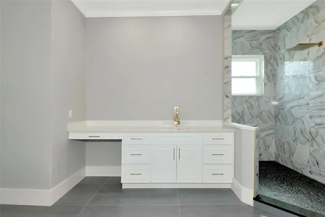 an empty room with wooden floor windows and entrance