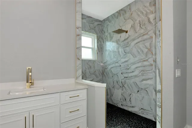 a view of a tennis ground with large trees