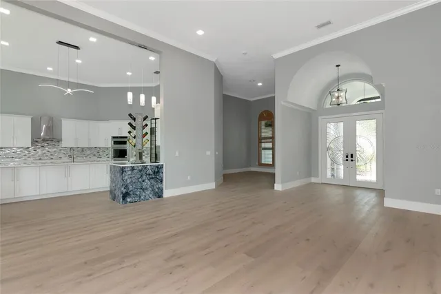 a kitchen with granite countertop white cabinets and stainless steel appliances