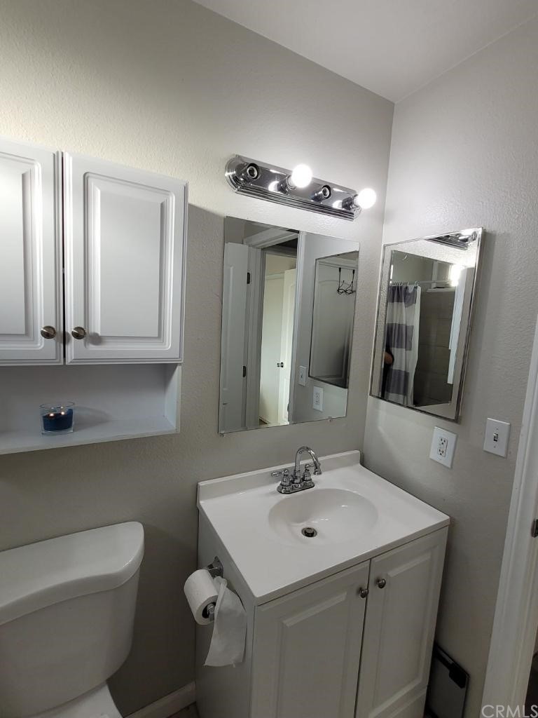 42901 Alexo Drive Lancaster, CA 93536 - Photo 13 of 20 a bathroom with a toilet sink and mirror