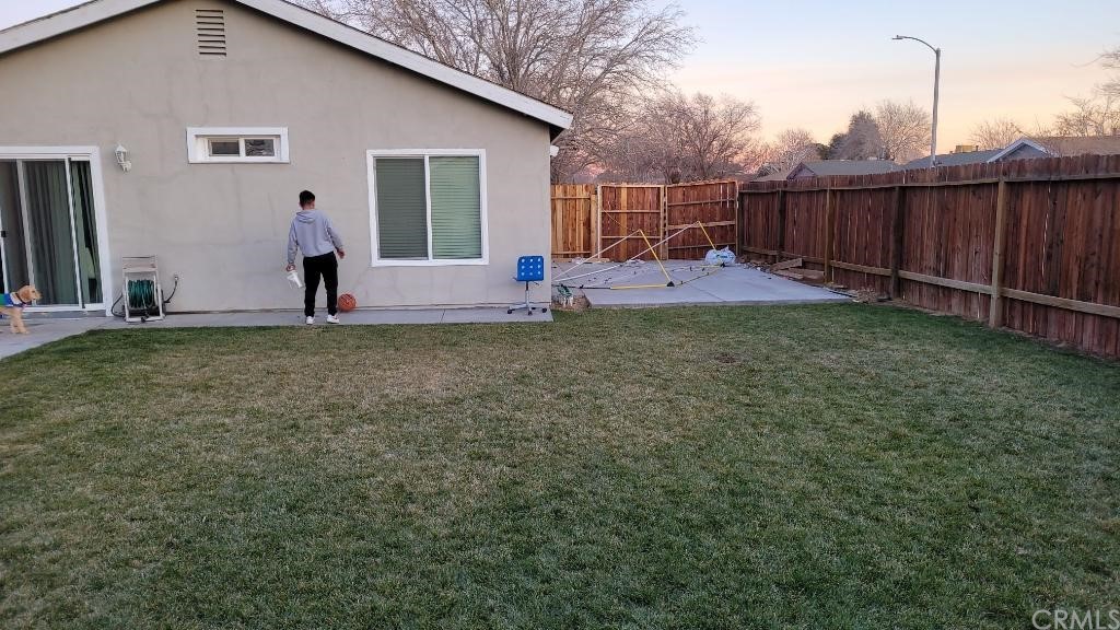 42901 Alexo Drive Lancaster, CA 93536 - Photo 3 of 20 a view of a backyard with a fence