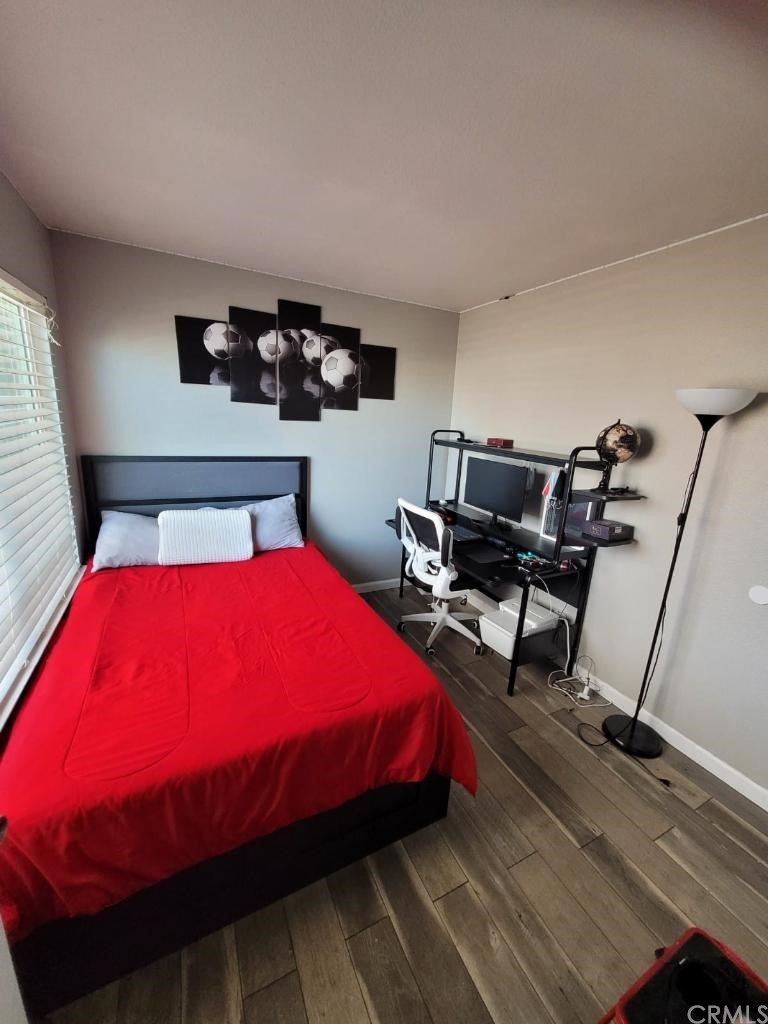 42901 Alexo Drive Lancaster, CA 93536 - Photo 10 of 20 a bedroom with a bed and wooden floor