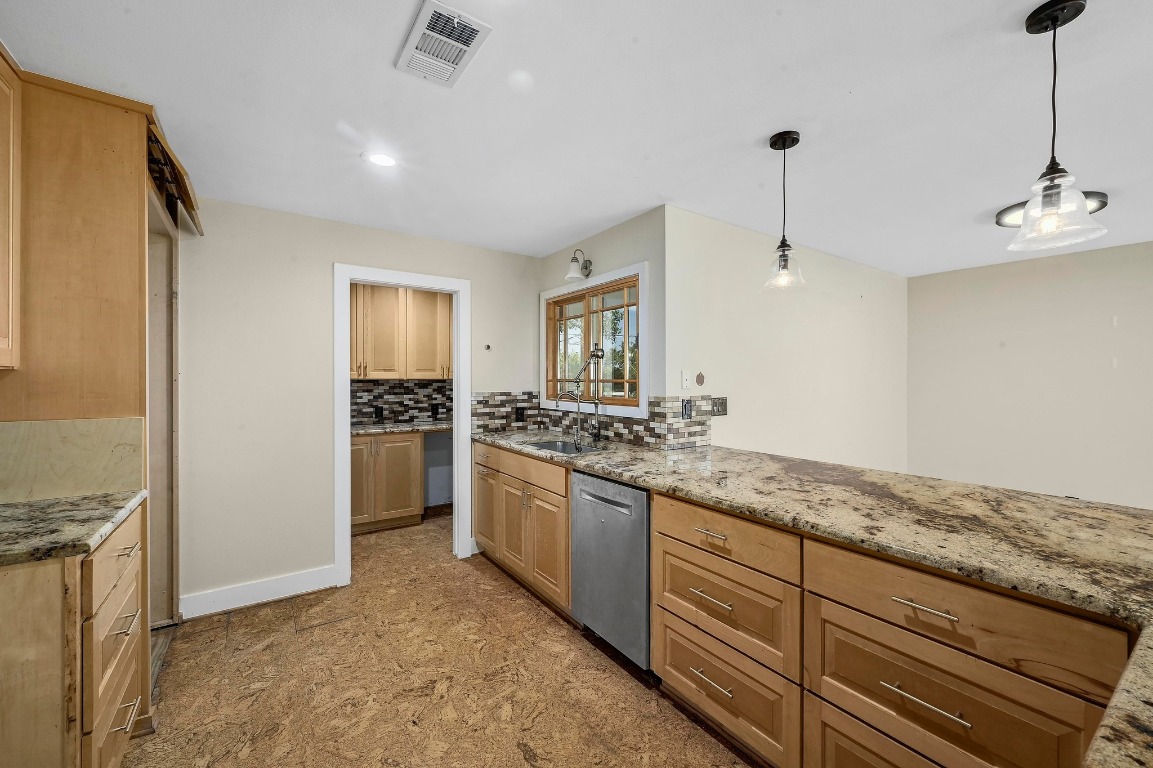 2204 Spring Creek Drive Austin, TX 78704 - Photo 11 of 34 a kitchen with stainless steel appliances granite countertop a sink and a refrigerator