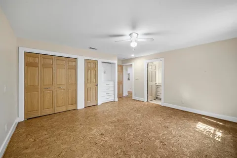 an empty room with closet area