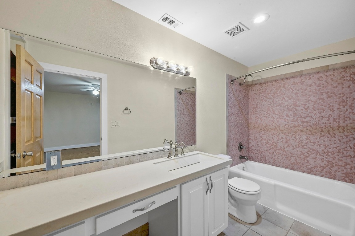2204 Spring Creek Drive Austin, TX 78704 - Photo 18 of 34 a bathroom with a granite countertop sink a toilet and shower