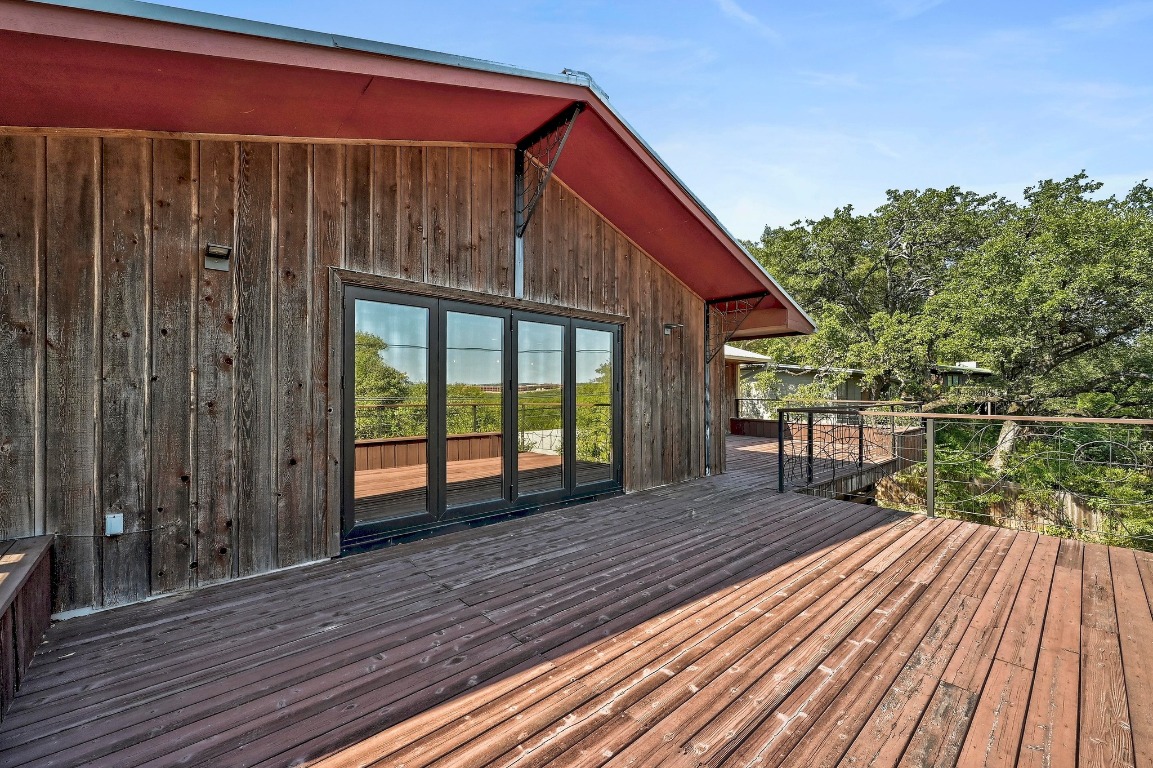 2204 Spring Creek Drive Austin, TX 78704 - Photo 20 of 34 a balcony with wooden floor table and chairs