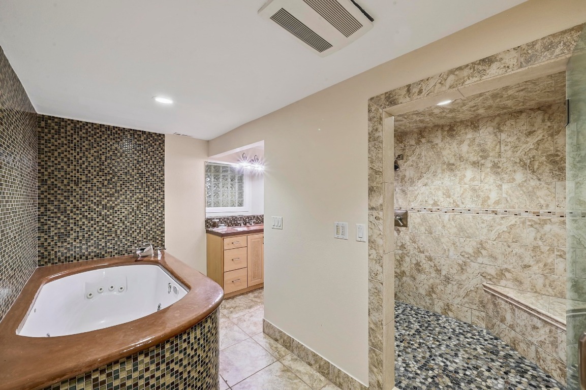 2204 Spring Creek Drive Austin, TX 78704 - Photo 24 of 34 a bathroom with a bathtub and shower