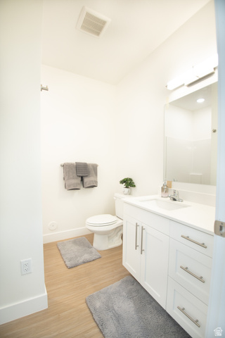 2085 North Main Street, Unit 412 Sunset, UT 84015 - Photo 6 of 14 Modern bathroom featuring a white vanity with brushed nickel hardware, a white sink, and light wood-finish flooring