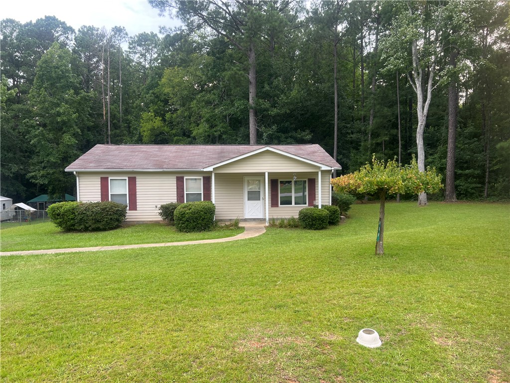 489 Talbert Road McCormick, SC 29835 - Photo 1 of 13 A welcoming home framed by nature, featuring a neat lawn and mature trees.
