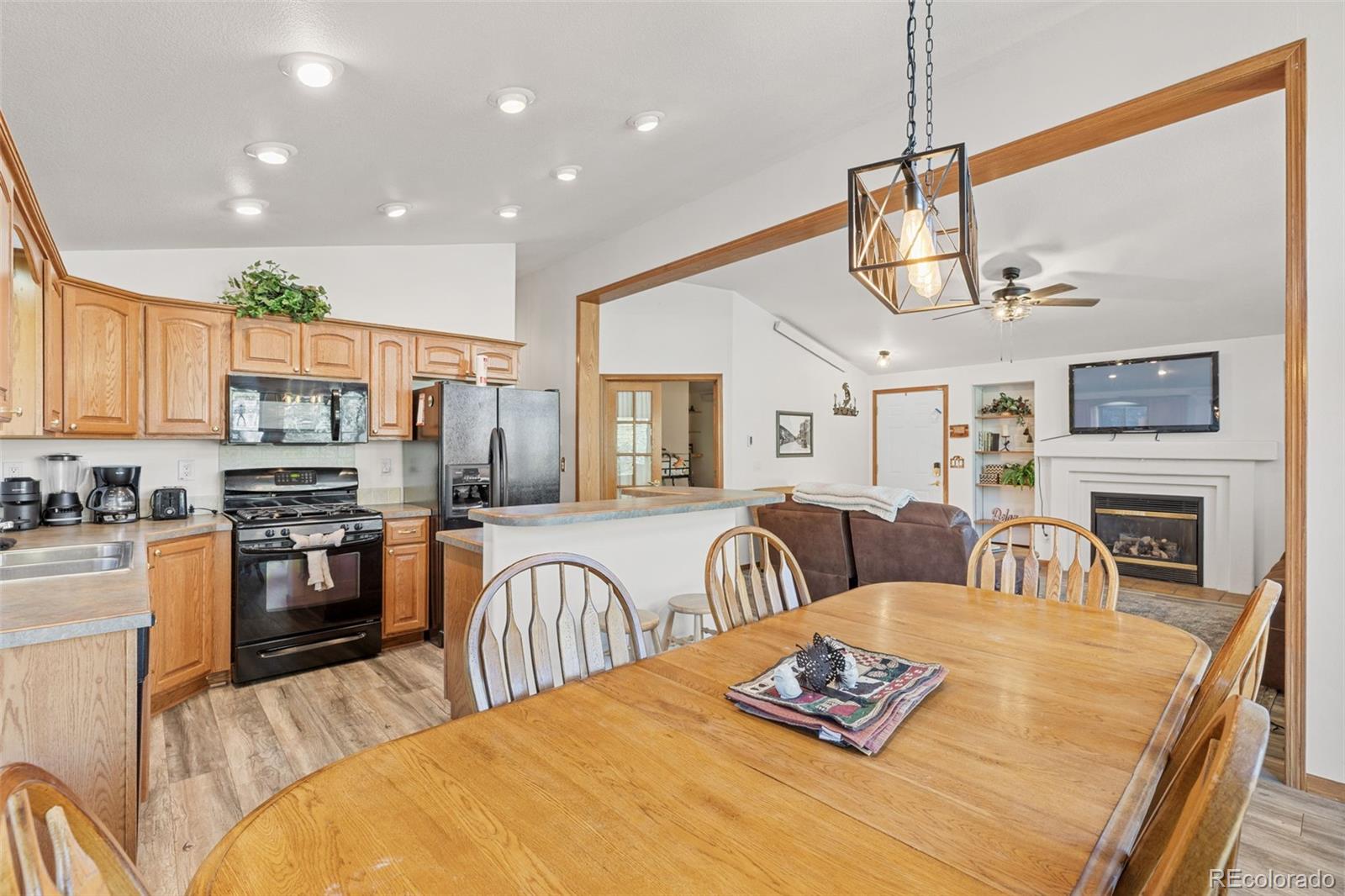 76 Wheel Haven Road Idaho Springs, CO 80452 - Photo 16 of 50 a bed room with fireplace and flat screen tv