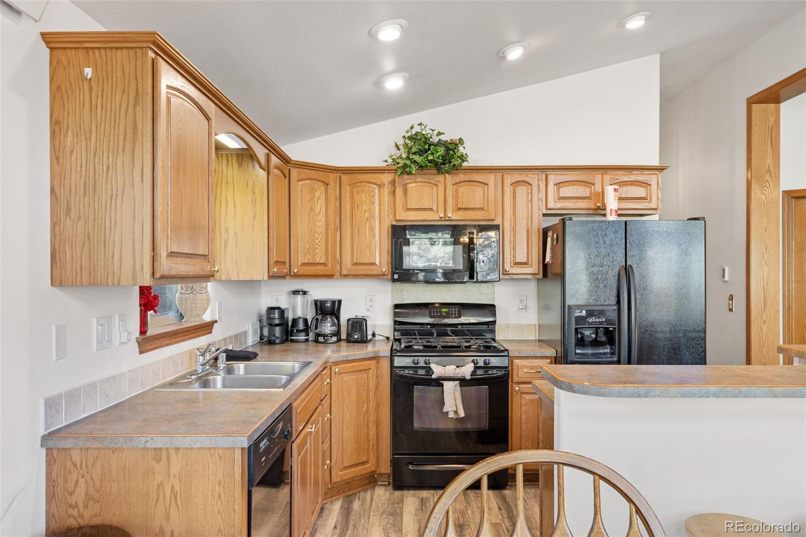 76 Wheel Haven Road Idaho Springs, CO 80452 - Photo 17 of 50 a kitchen with stainless steel appliances granite countertop a refrigerator a stove top oven a sink and dishwasher