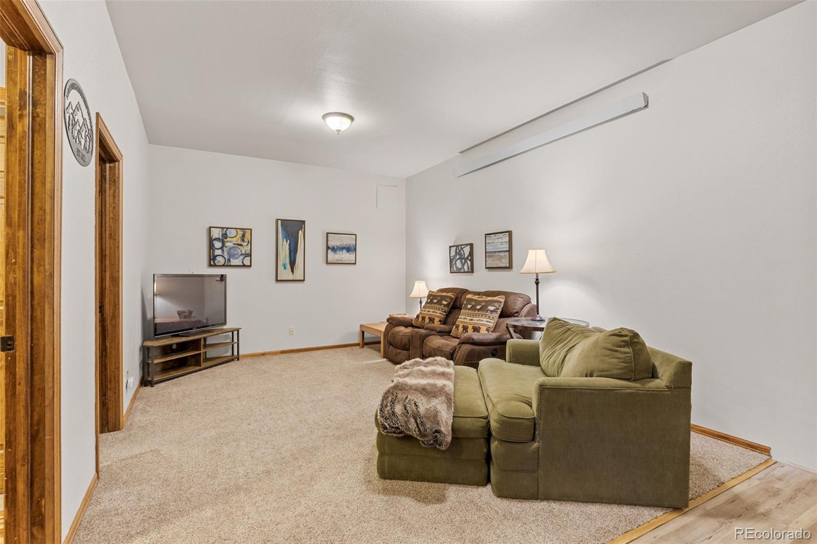 76 Wheel Haven Road Idaho Springs, CO 80452 - Photo 36 of 50 a living room with furniture and a flat screen tv