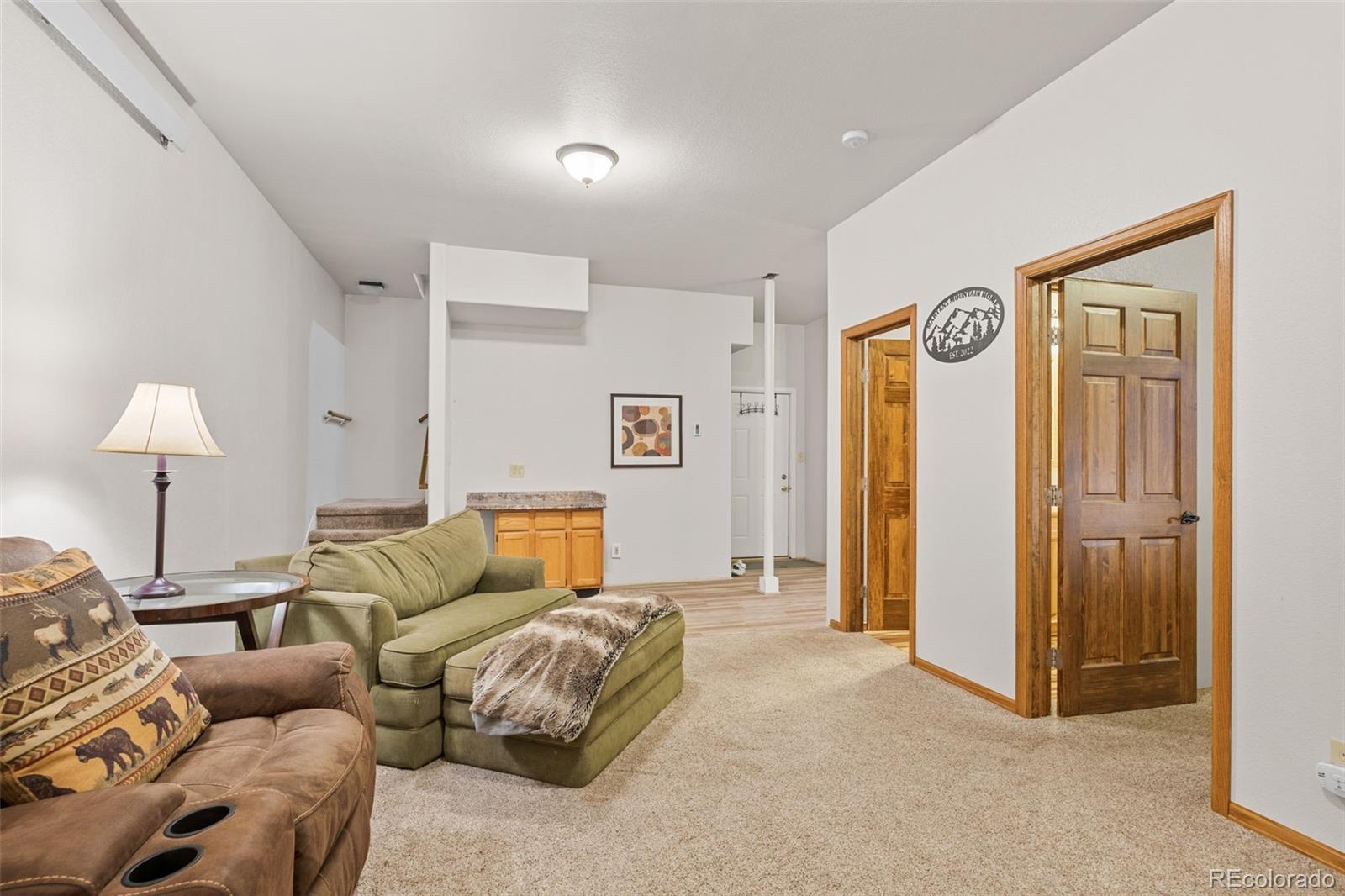 76 Wheel Haven Road Idaho Springs, CO 80452 - Photo 37 of 50 a living room with furniture and a lamp