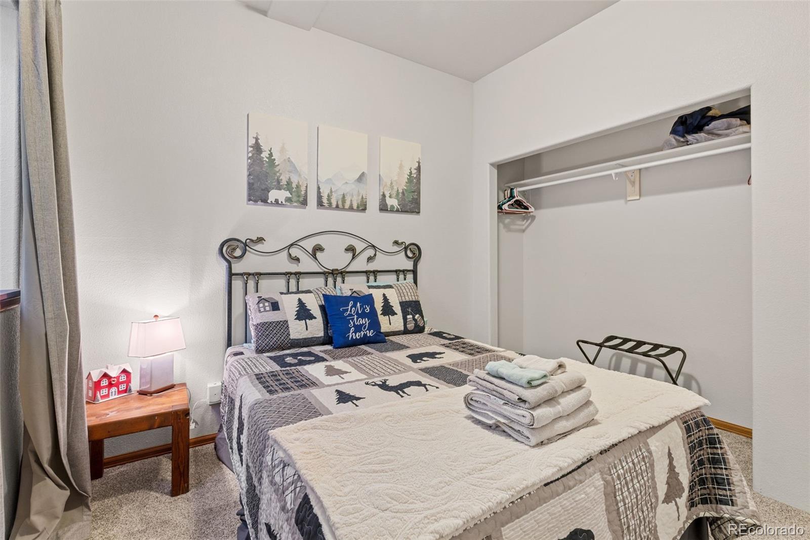 76 Wheel Haven Road Idaho Springs, CO 80452 - Photo 39 of 50 a bedroom with a bed and dresser