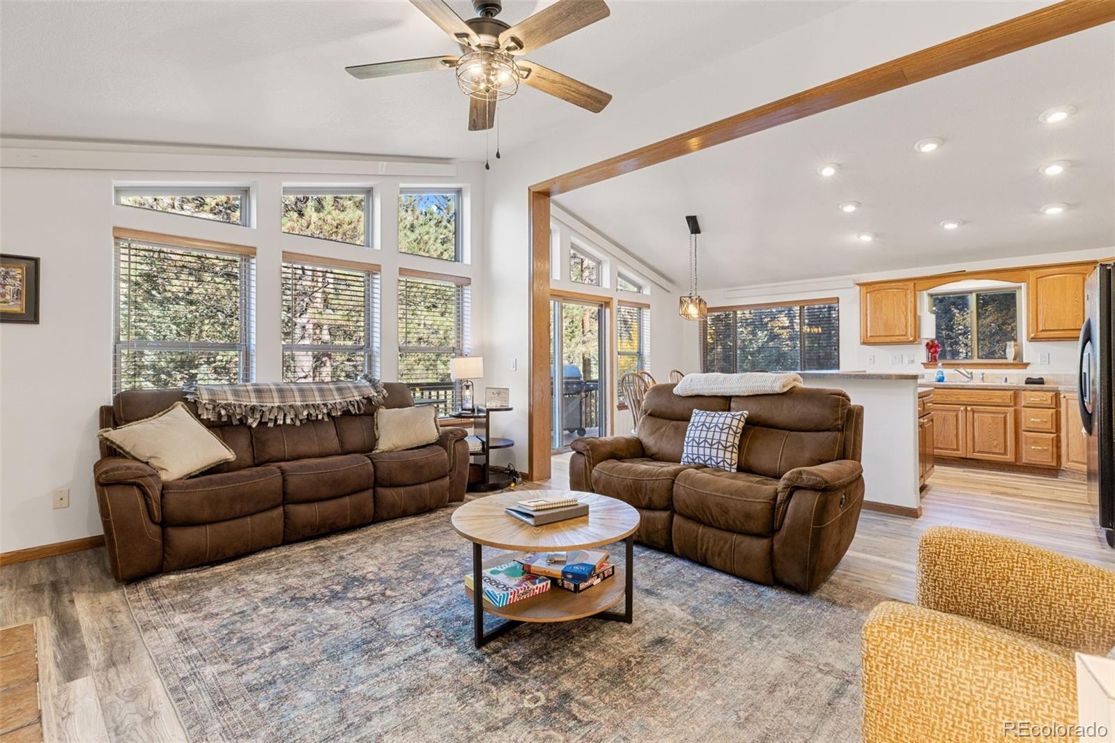 76 Wheel Haven Road Idaho Springs, CO 80452 - Photo 6 of 50 a living room with furniture a large window and a chandelier