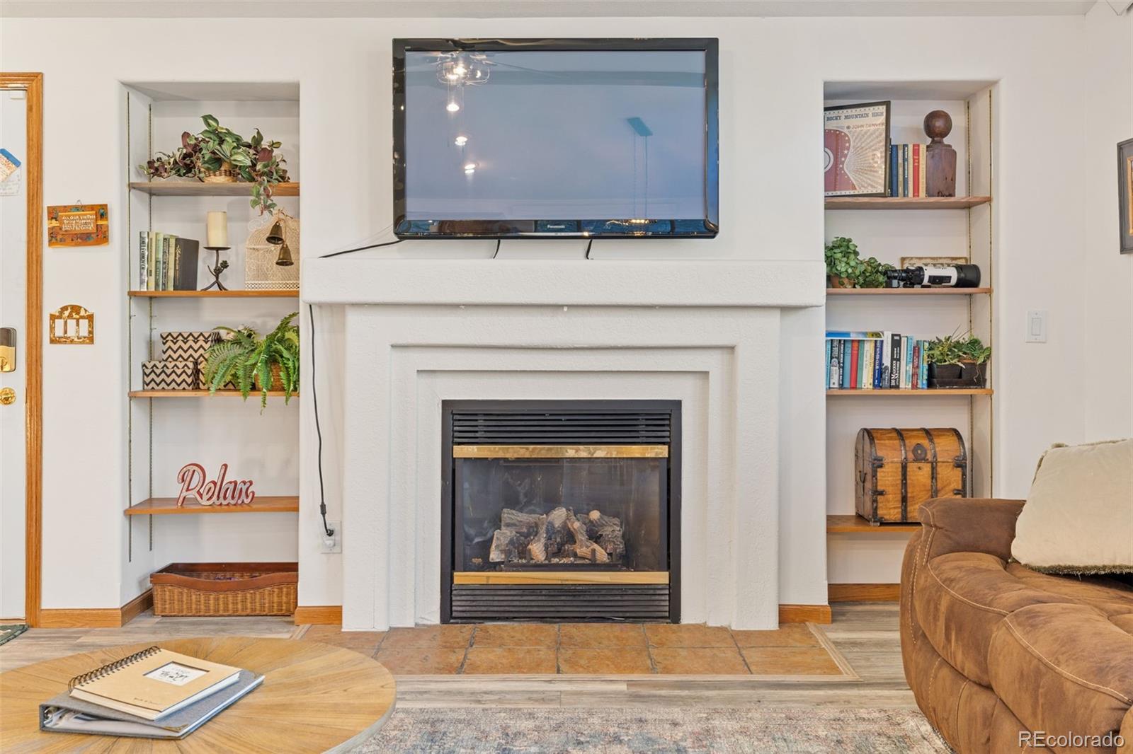 76 Wheel Haven Road Idaho Springs, CO 80452 - Photo 8 of 50 a living room with furniture and a fireplace