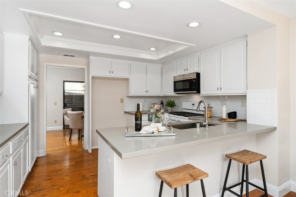 25721 Shell Drive Dana Point, CA 92629 - Photo 12 of 41 a kitchen with stainless steel appliances granite countertop a stove a sink a refrigerator and a microwave