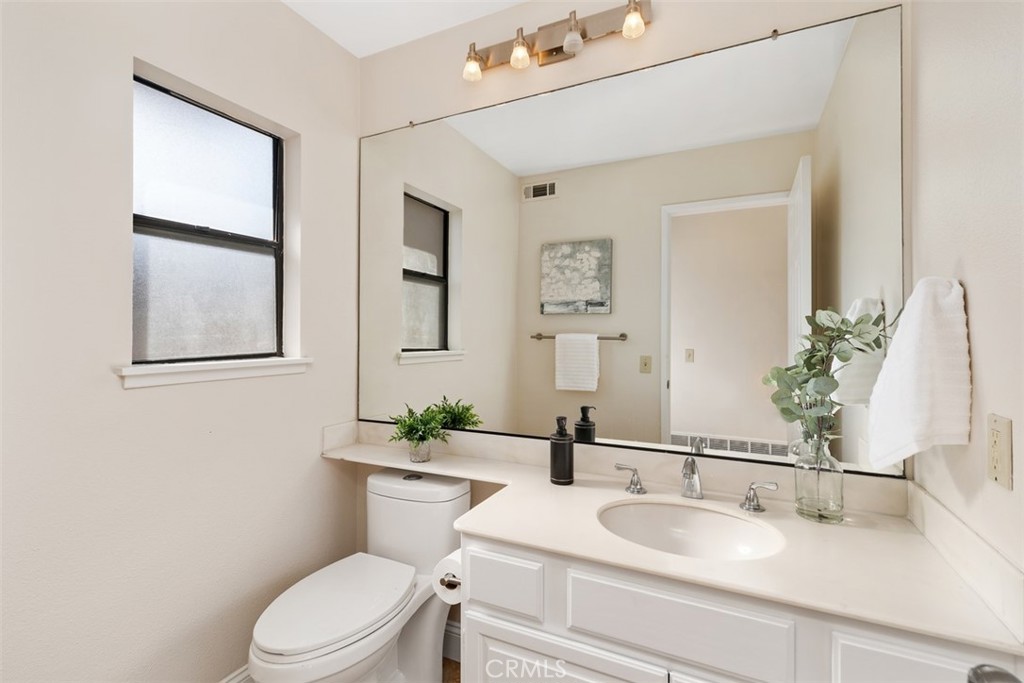 25721 Shell Drive Dana Point, CA 92629 - Photo 17 of 41 a bathroom with a granite countertop toilet sink and mirror