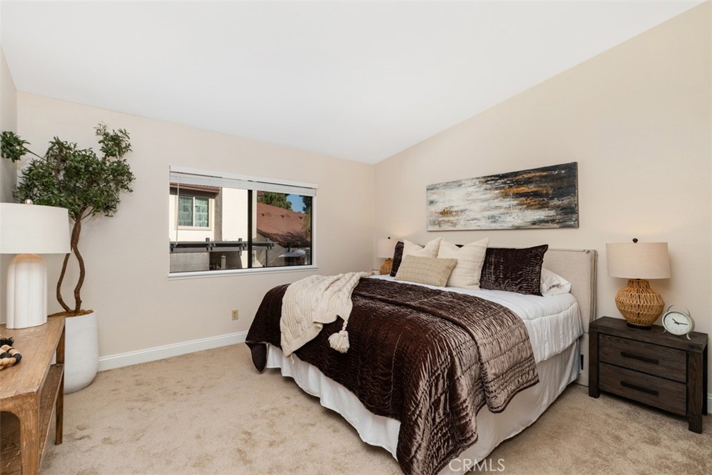 25721 Shell Drive Dana Point, CA 92629 - Photo 23 of 41 a spacious bedroom with a bed and a potted plant on the dresser
