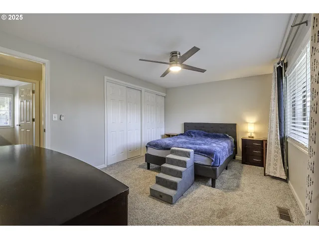 a spacious bedroom with a bed and a chandelier