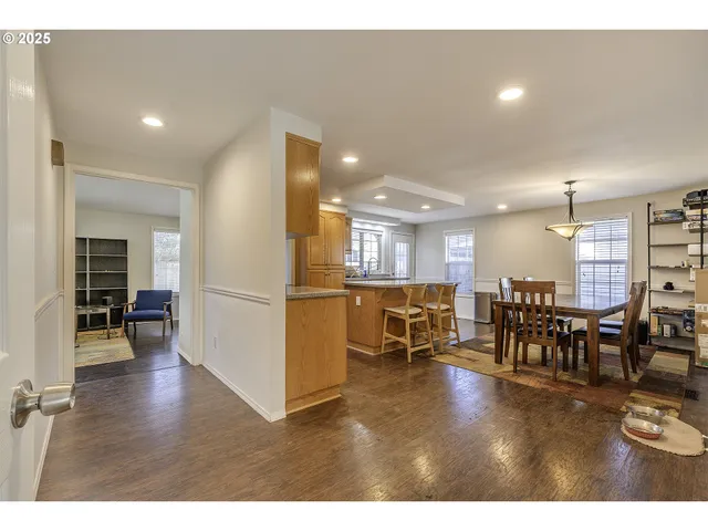 a living room with lots of furniture and kitchen view