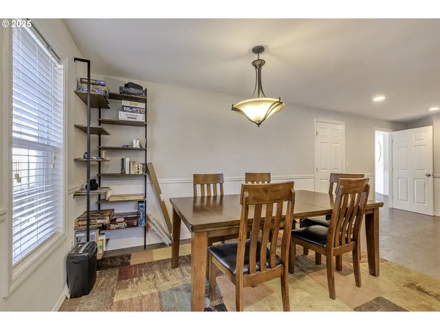 a view of a dining room with furniture and chandelier