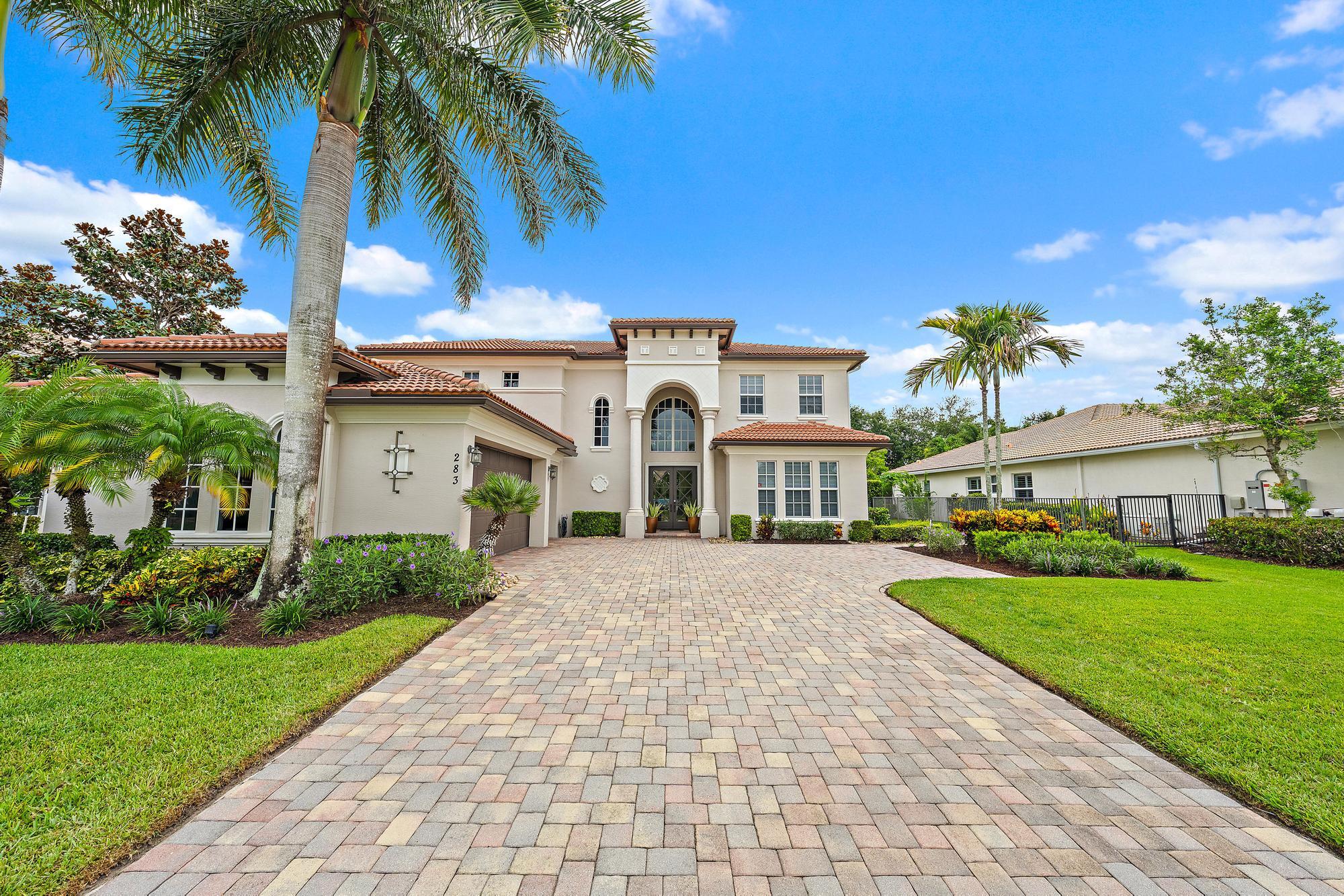 283 Rudder Cay Way Jupiter, FL 33458 - Photo 17 of 41 a front view of house with yard and green space