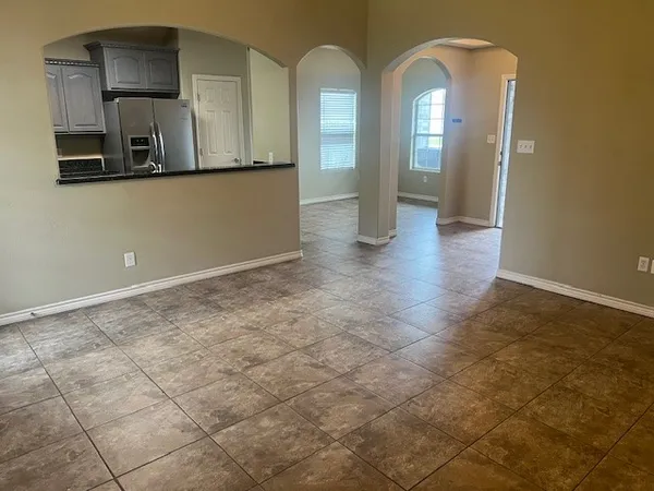 a view of a bathroom with mirror and tiles