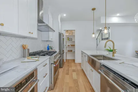 a kitchen with a sink stove and cabinets
