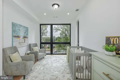 a living room with furniture and large windows