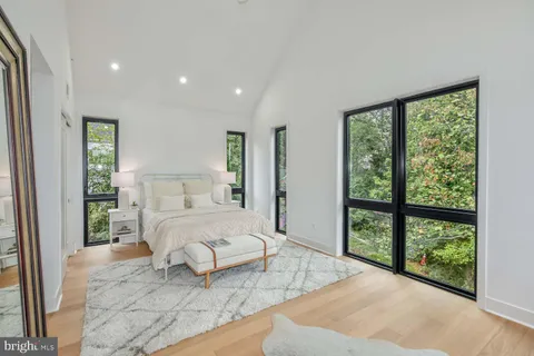 a bedroom with a large bed and a large window