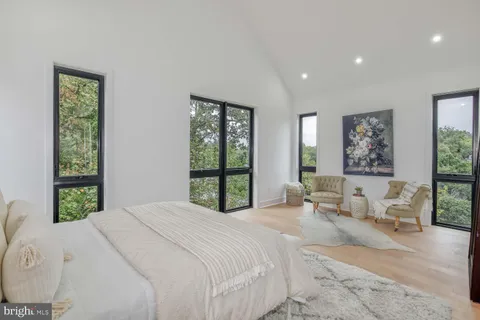 a bedroom with a large bed and a large window