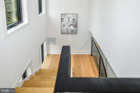 a view of staircase with wooden floor and a window