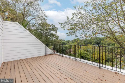 a terrace view with wooden floor and fence