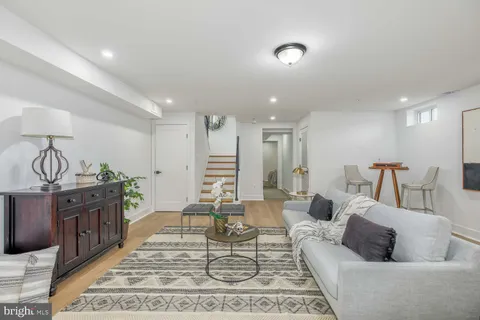 a living room with furniture a rug and a chandelier
