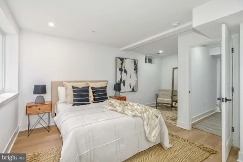 a bedroom with a bed and chair