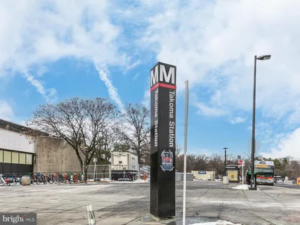 a street sign on a sidewalk next to a road