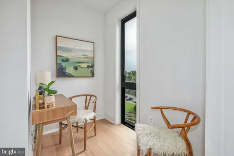 a view of a workspace with furniture and a potted plant