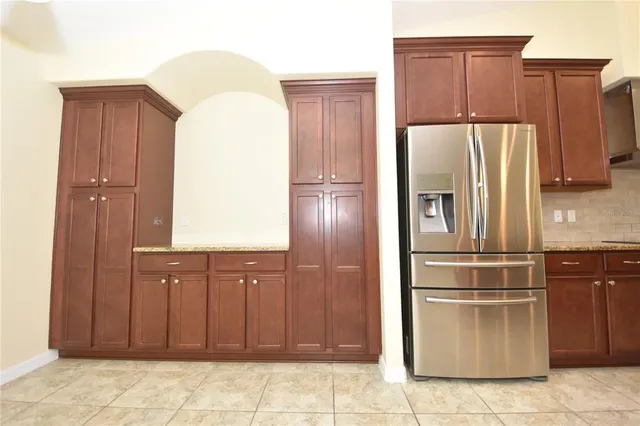 a kitchen with stainless steel appliances granite countertop a refrigerator and a sink
