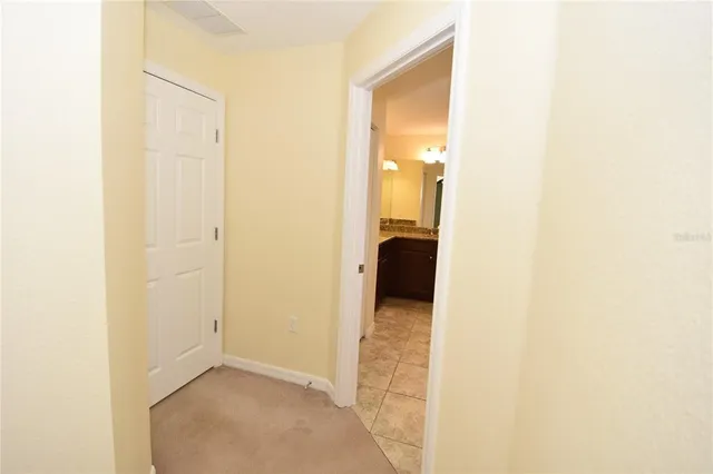 a bathroom with a granite countertop sink a mirror and a bathtub