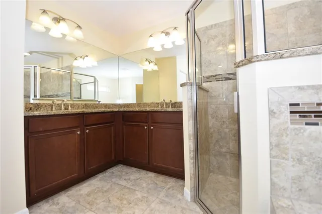 a large kitchen with kitchen island a counter top space a sink stainless steel appliances and cabinets