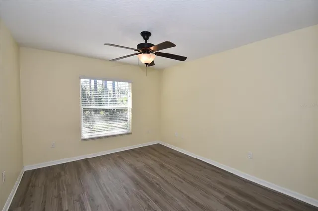 a view of a ceiling fan and wooden floor