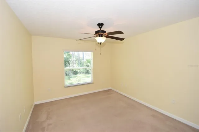 a view of a room with a ceiling fan and a window